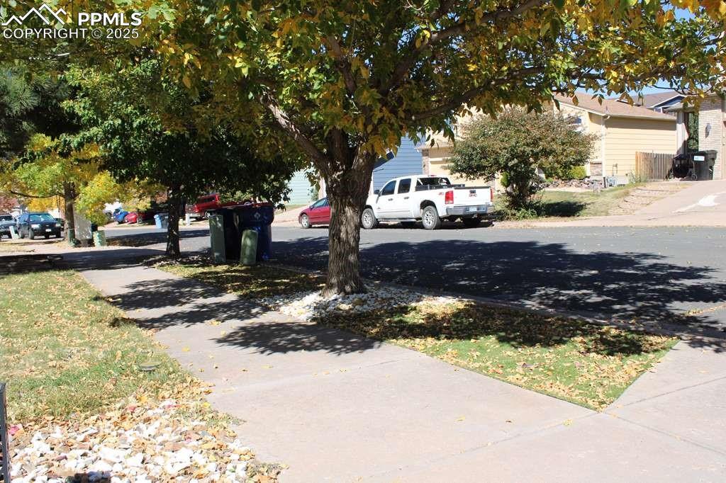 View of asphalt road featuring sidewalks