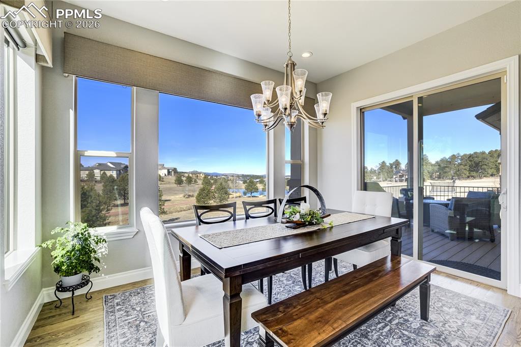 Dining space positioned to capture pond + mountain outlook with seamless transition to covered outdoor living.
