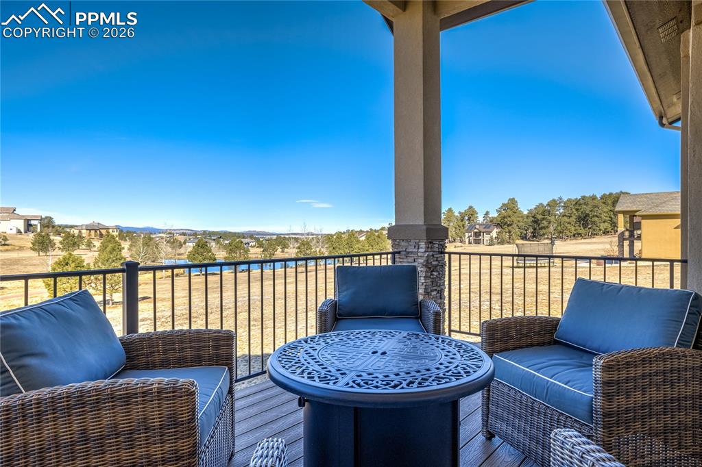 Covered composite deck extending the main-level living—elevated above the landscape for layered views.
