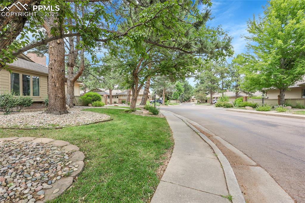 View of asphalt street with sidewalks, a residential view, and curbs