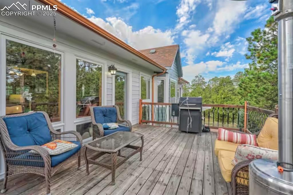 Wooden deck with area for grilling and outdoor lounge area