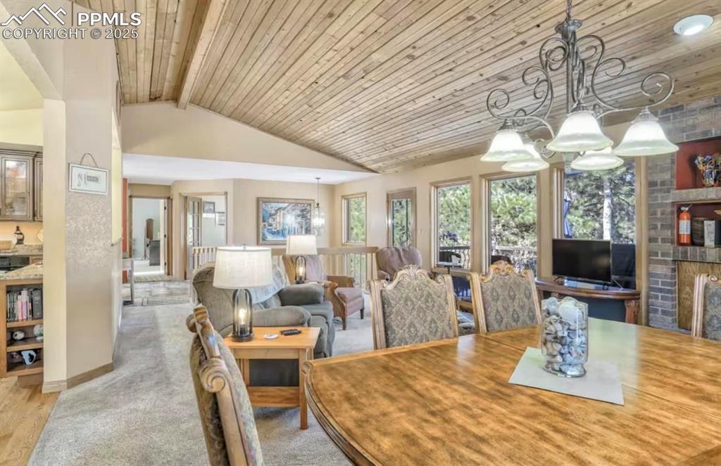 Dining room with wood ceiling and carpet floors