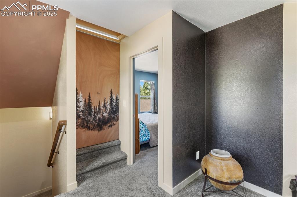 Landing at top of stairs on main level. Bi-fold doors to stairs to the upstairs nonconforming bedroom/living room/family room.