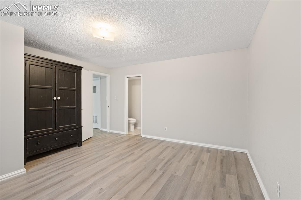This can be a junior primary suite with attached 1/2 bath and large armoire (it stays!)