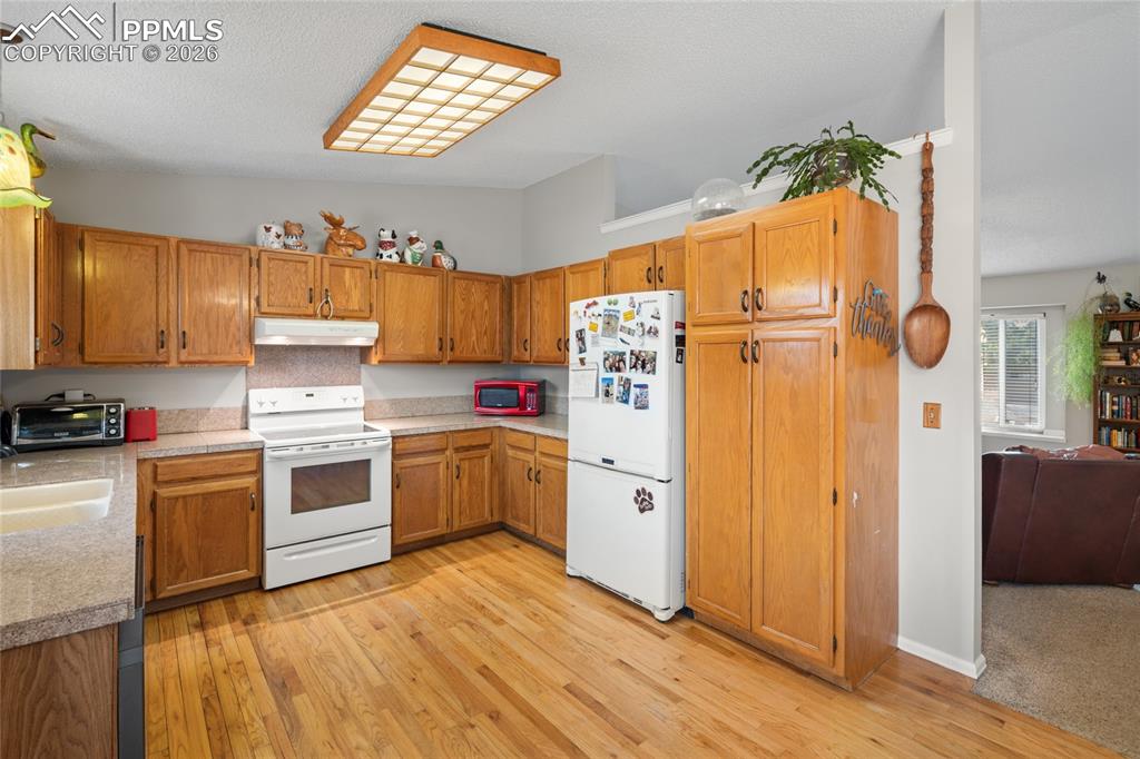 The kitchen has a convenient pantry cabinet.