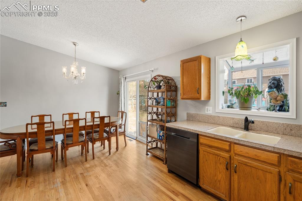 View from kitchen into the dining area. Pretty plant window over the sink.