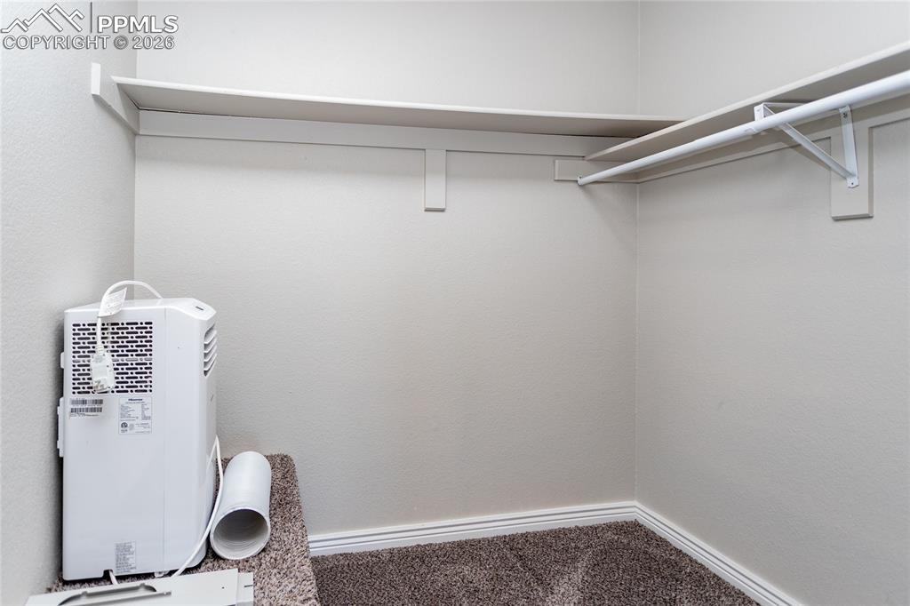 Primary bedroom walk-in closet