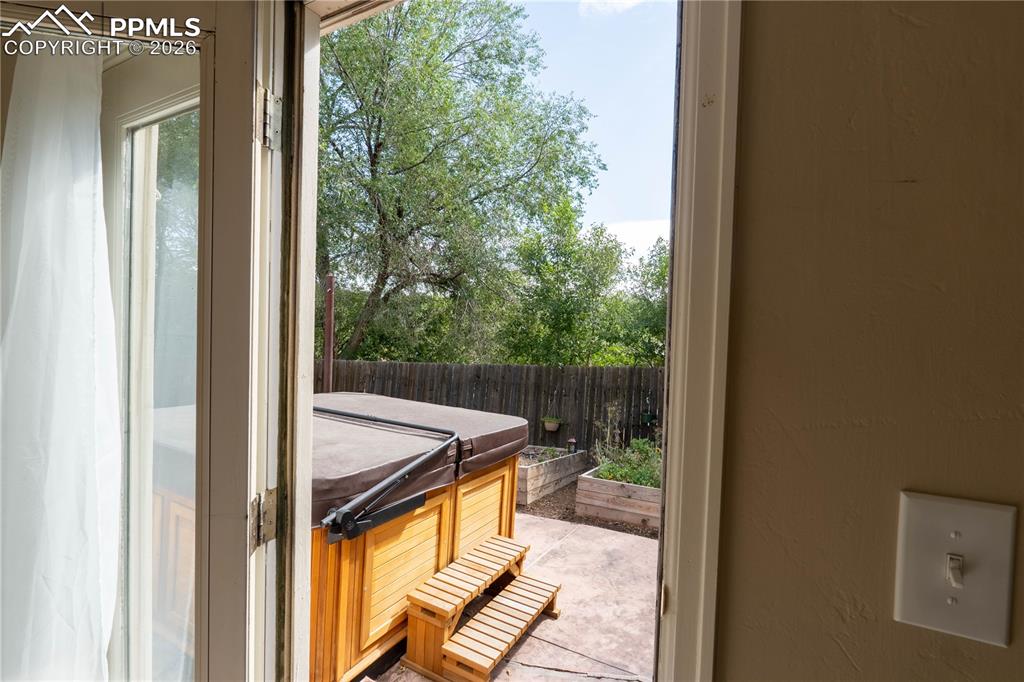 Primary bedroom features a walkout to the wraparound patio