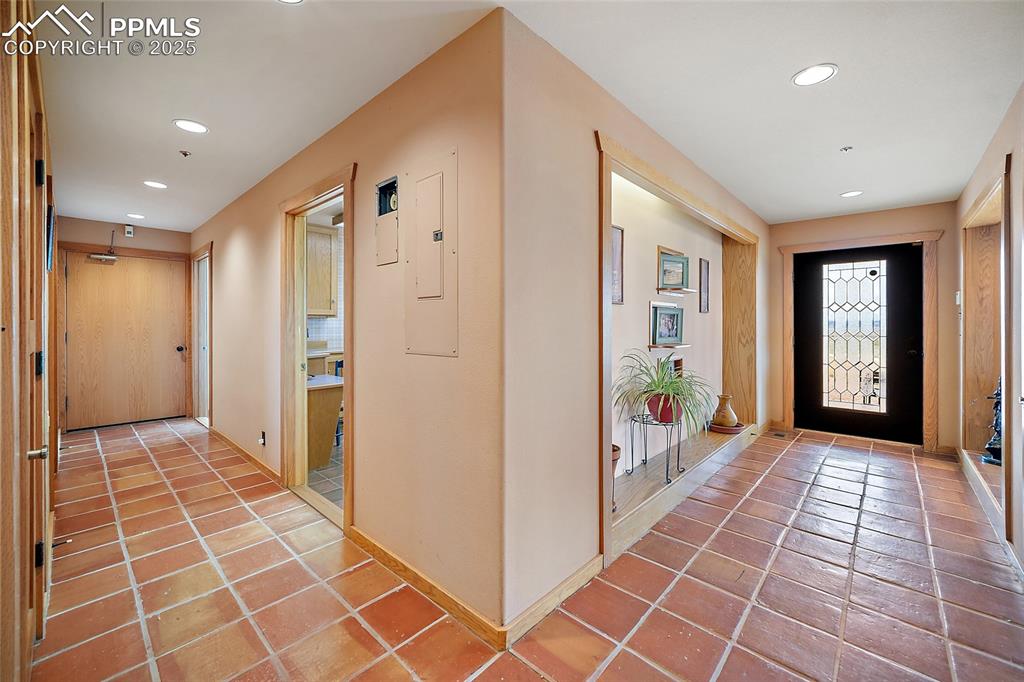 Tiled entrance foyer featuring recessed lighting and electric panel