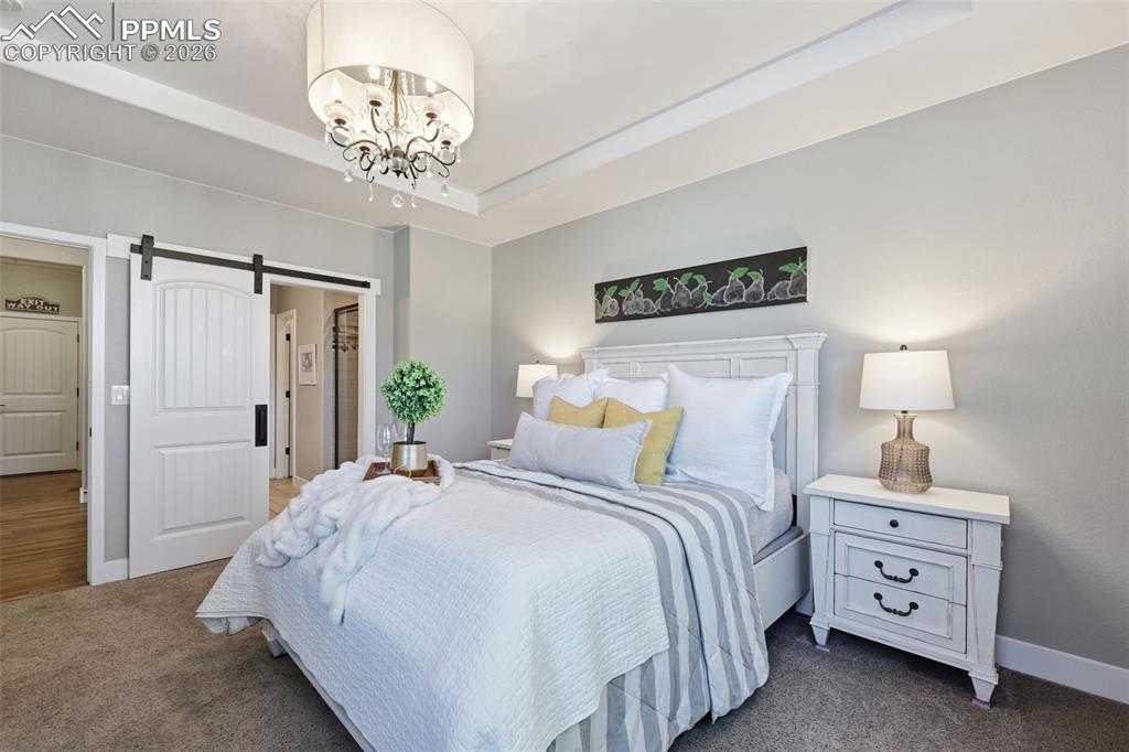 Custom chandelier and barn door in the master bedroom!