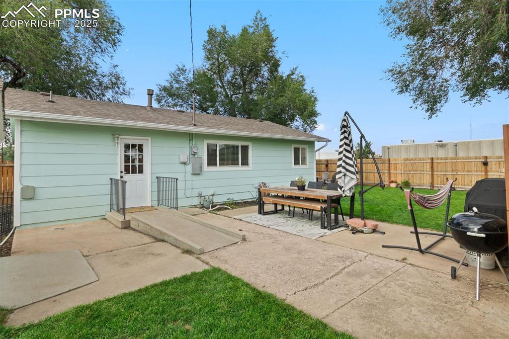 VIEW OF BACK OF HOME & DOOR OFF KITCHEN