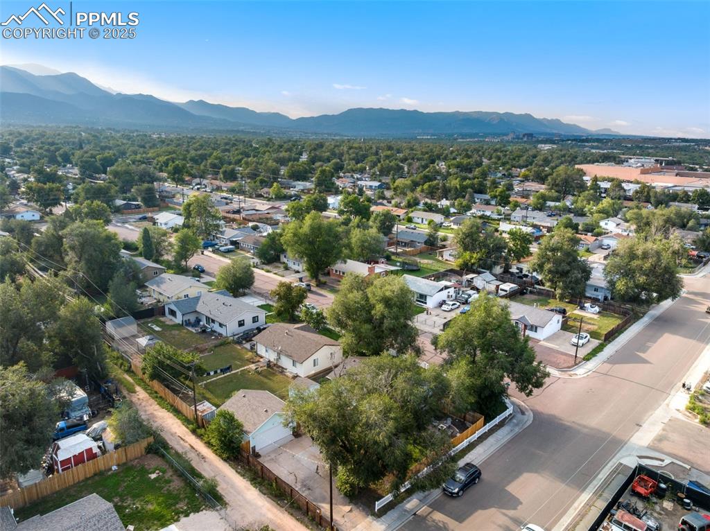 AERIAL VIEW FROM BACK OF HOME SHOWING GARAGE & MOUNTAINS