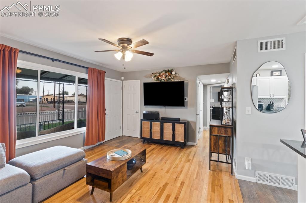 HARDWOOD FLOORS & CEILING FAN IN LIVING ROOM