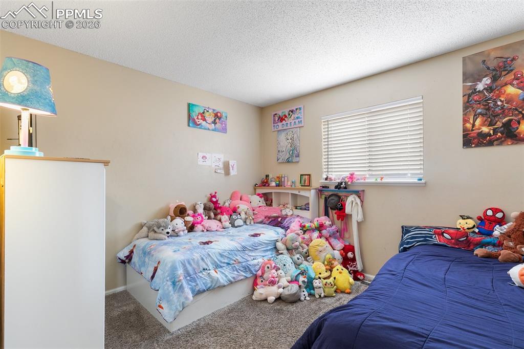Bedroom with carpet floors and a textured ceiling
