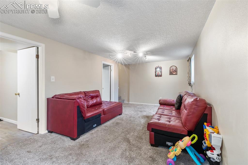 Carpeted living area with a textured ceiling