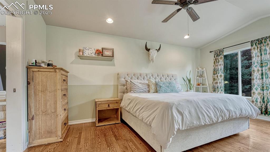 Bedroom featuring recessed lighting, wood finished floors, vaulted ceiling, and ceiling fan