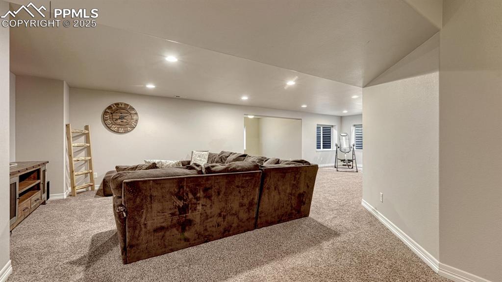 Cinema room with recessed lighting, light carpet, and vaulted ceiling