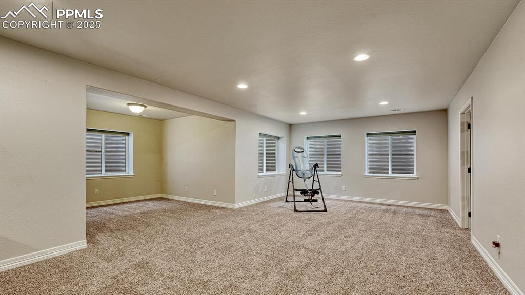 Exercise area featuring light carpet and recessed lighting
