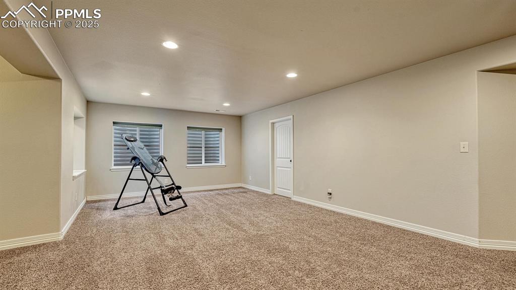 Exercise room with carpet flooring and recessed lighting