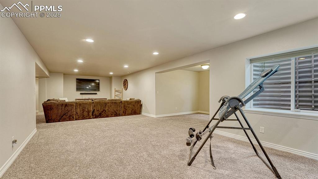 Exercise area featuring recessed lighting and light carpet