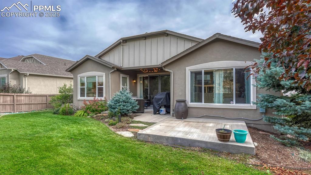 Rear view of house with a patio and stucco siding