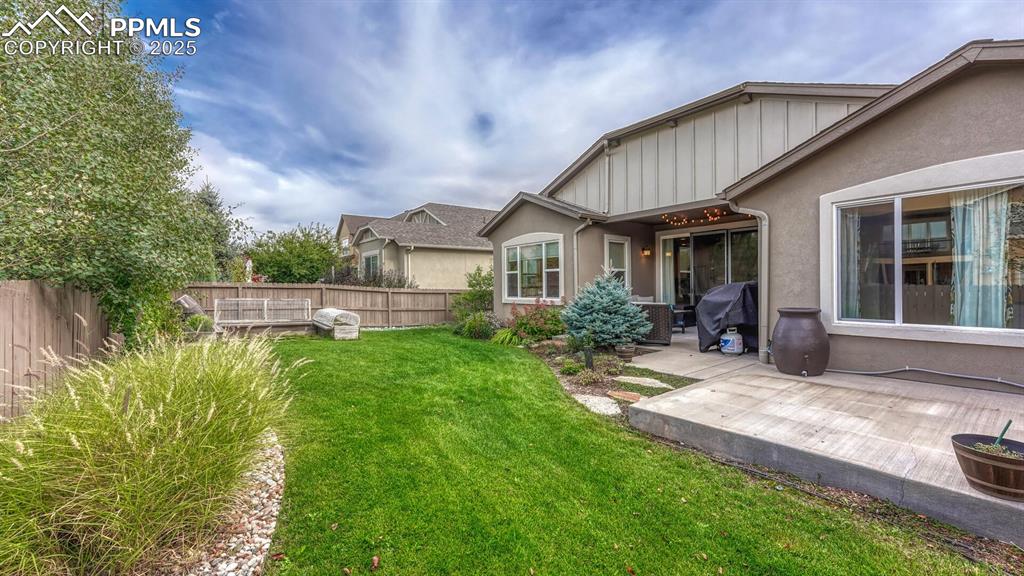 Fenced backyard with a patio