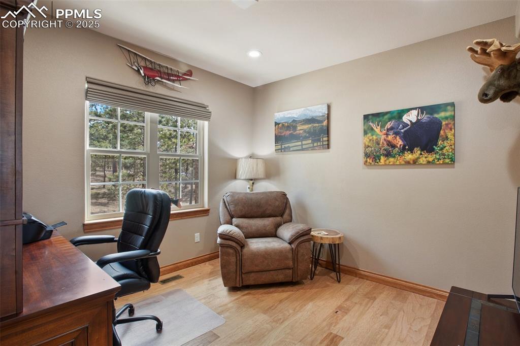 Home office with recessed lighting, visible vents, light wood-style flooring, and baseboards