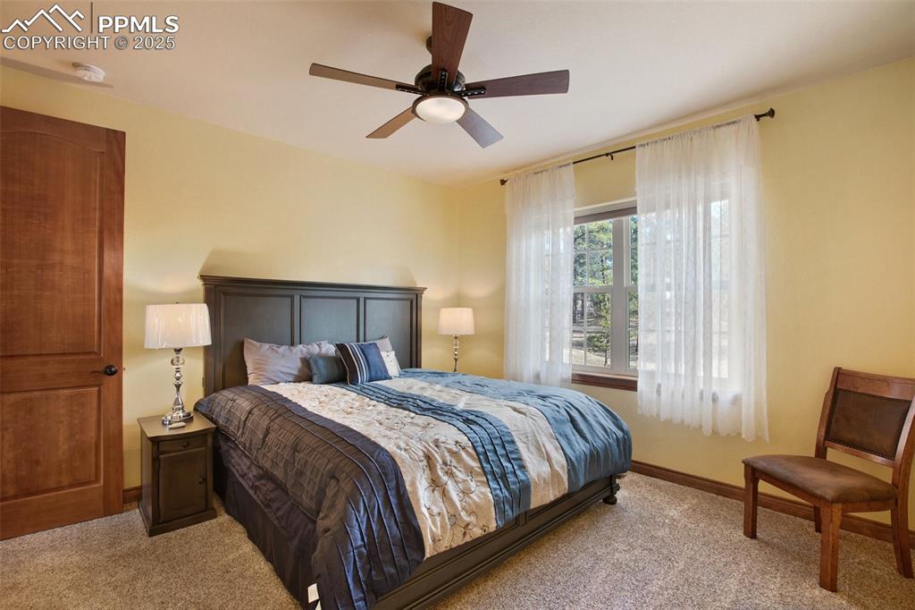 Bedroom featuring baseboards, carpet, and a ceiling fan
