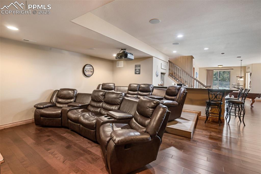 Cinema featuring recessed lighting, dark wood-style floors, and baseboards
