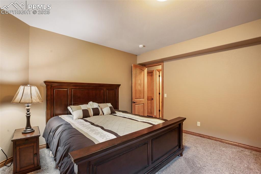Bedroom featuring light colored carpet and baseboards