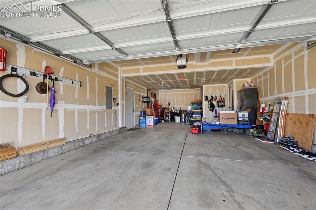 Three-car tandem garage with an exterior access door.