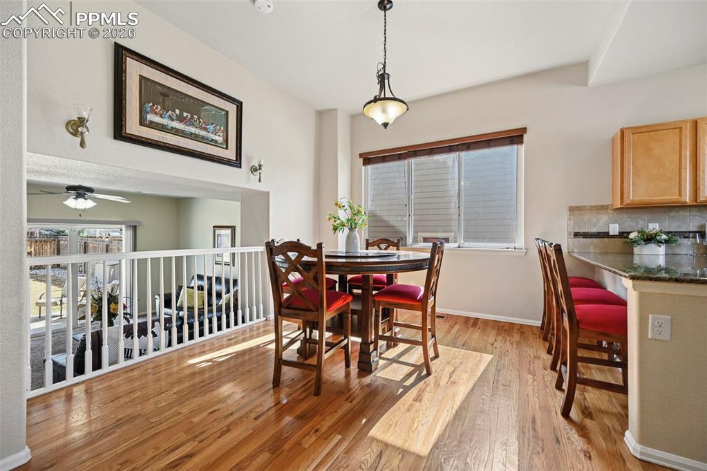 Open and spacious dining room featuing beautiful hardwood floors and lots of natural light.