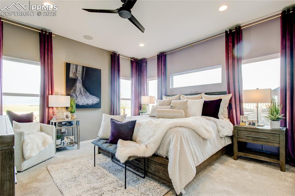 Bedroom featuring carpet floors, ceiling fan, and recessed lighting