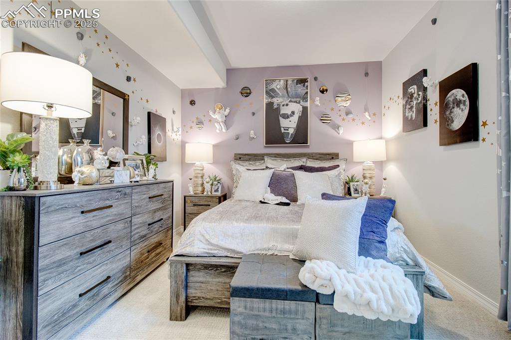 Bedroom with light carpet and baseboards