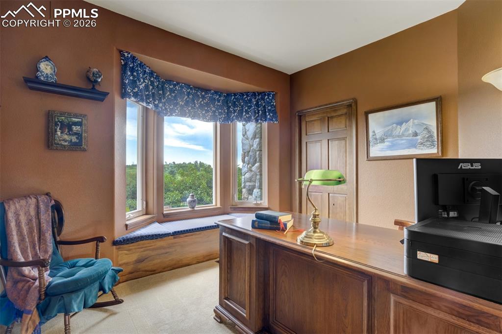 Main level bedroom #2 overlooks the front garden and serves as a wonderful home office