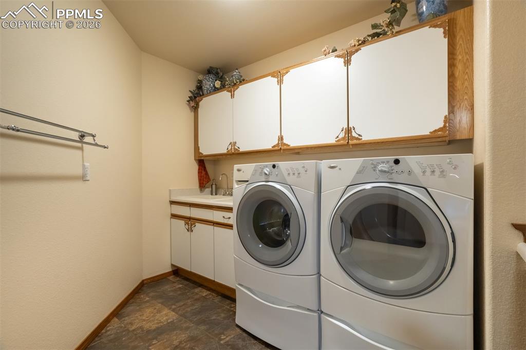 Spacious laundry room with folding counter and cabinetry