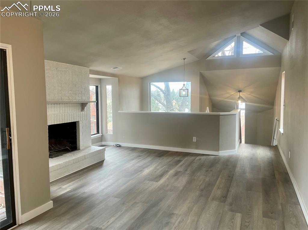 Looking from Dining Area toward Great Room fireplace. All flooring new. Fresh paint.