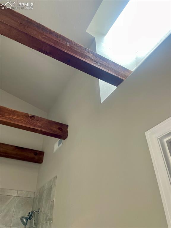 Detailed view of bathroom ceiling and windows.