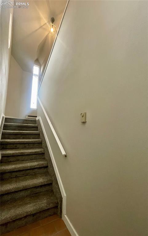 Looking from tile entry up the stair toward the rest of the condo.