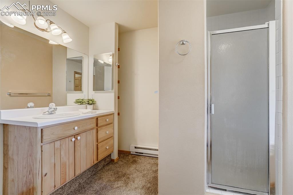 Primary bathroom with walk-in shower, soaking tub, and separate toilet room.