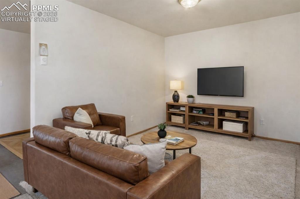 Virtually Staged - Versatile lower level room suitable for a second living area, office, or recreation space.