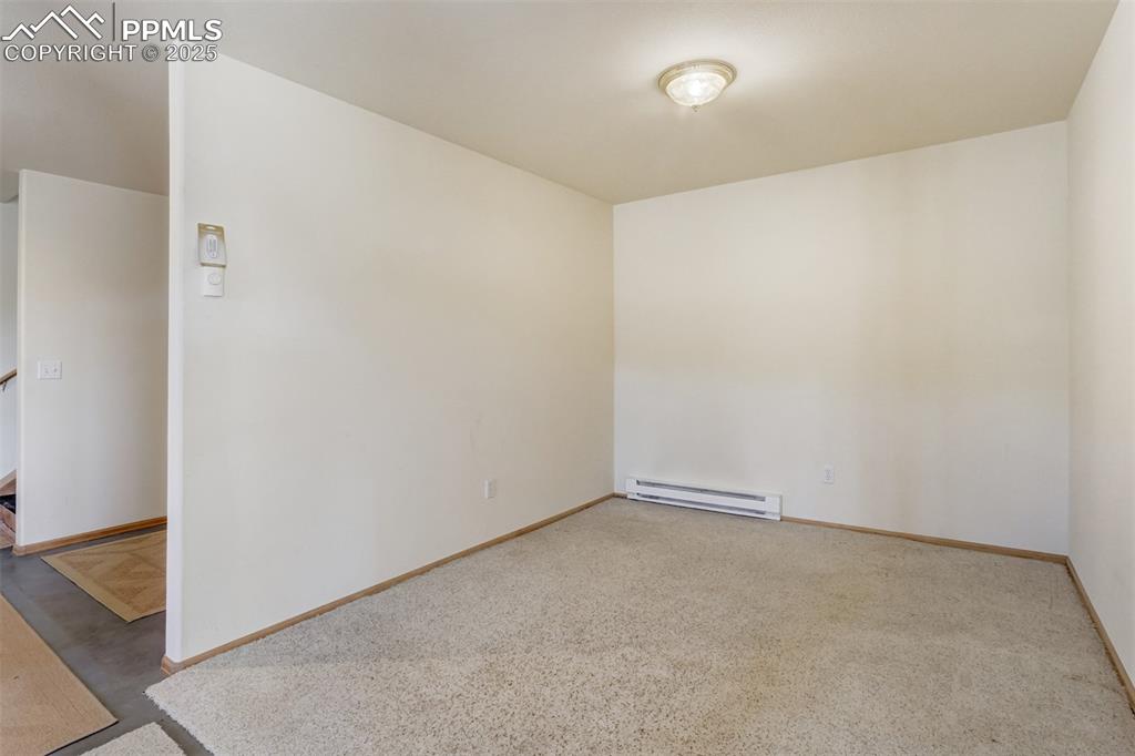 Versatile lower level room suitable for a second living area, office, or recreation space.