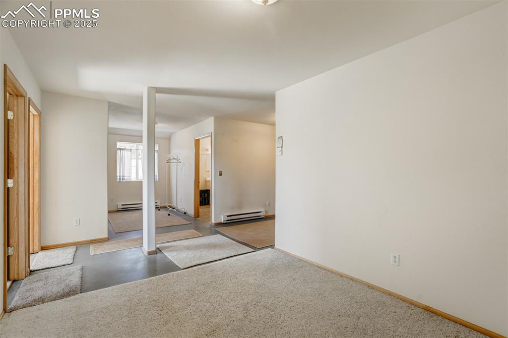 Lower level living area with access to the laundry room and bathroom.