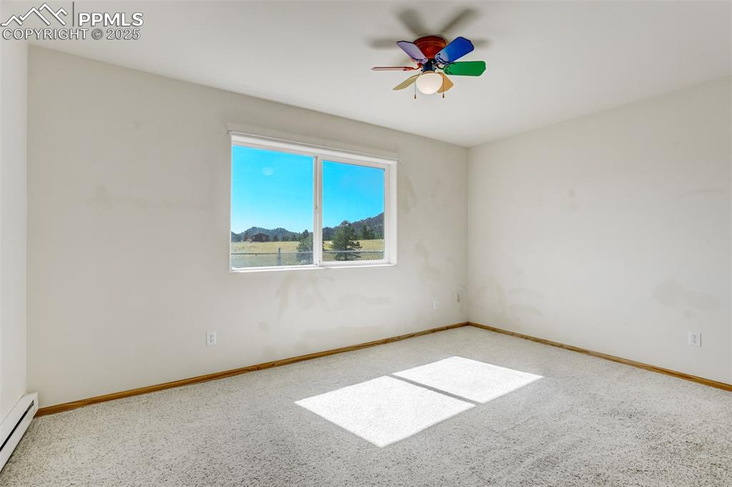 Bedroom with natural light and views of the surrounding area.