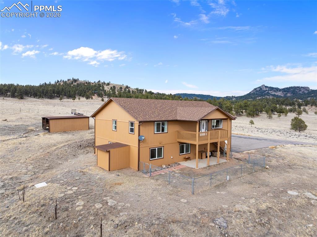 Exterior of the home featuring fresh stain and surrounding mountain views.