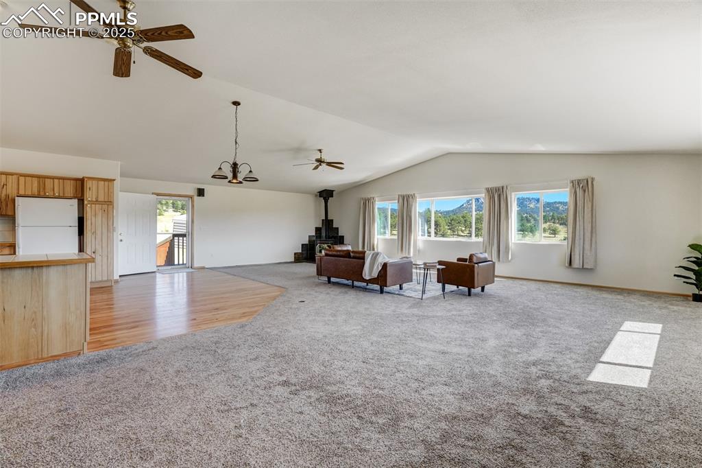 Spacious open living area with large windows, abundant natural light, and beautiful mountain views.
