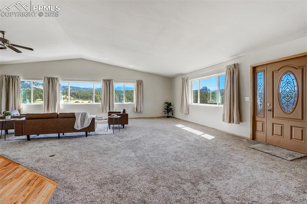 Spacious living room filled with natural light and framed by scenic mountain views.
