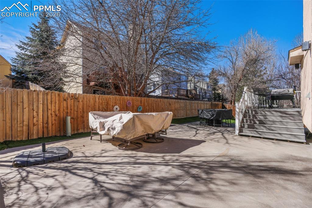 Back of house featuring Astroturf, deck and private backyard