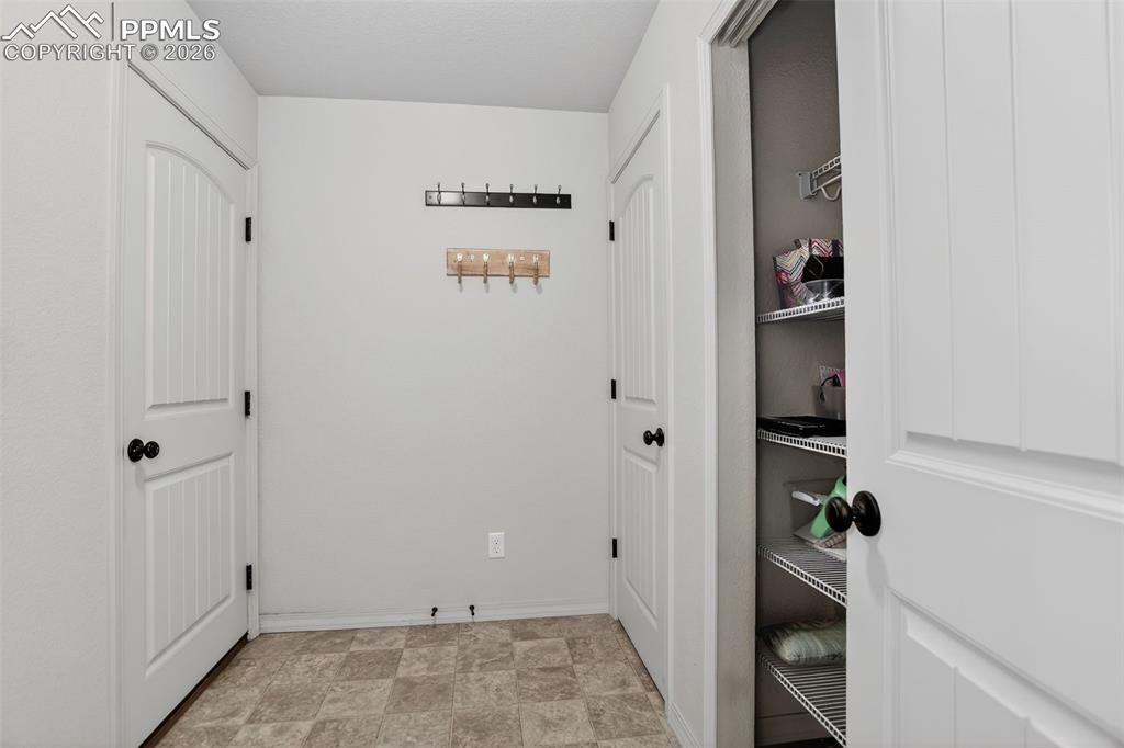Mudroom with closet and shelving