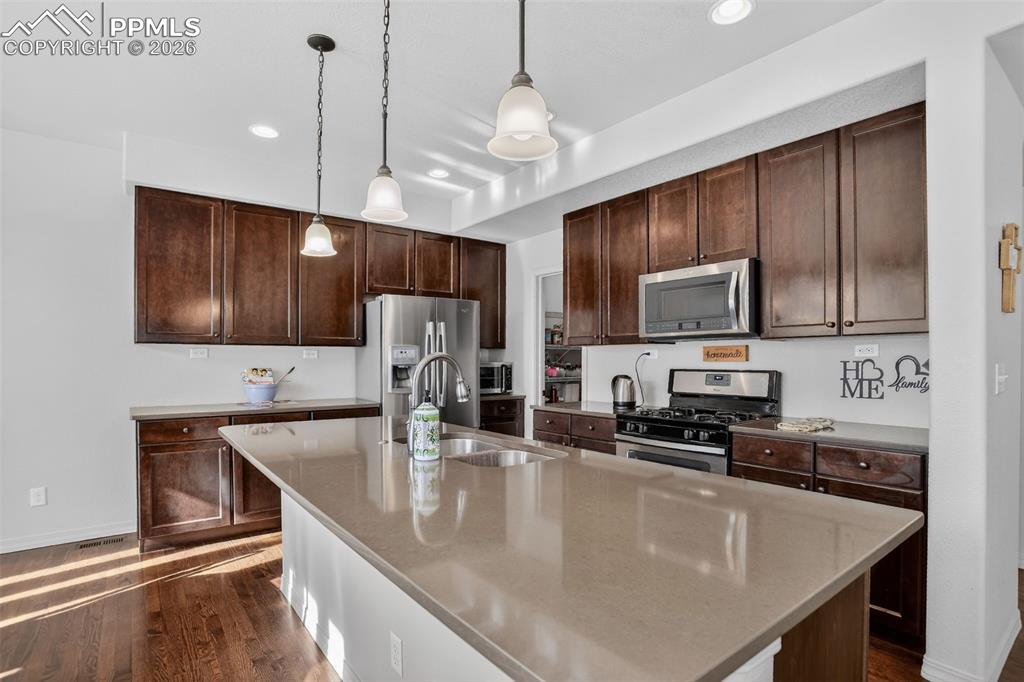 Kitchen ss appliances and maple cabinetry